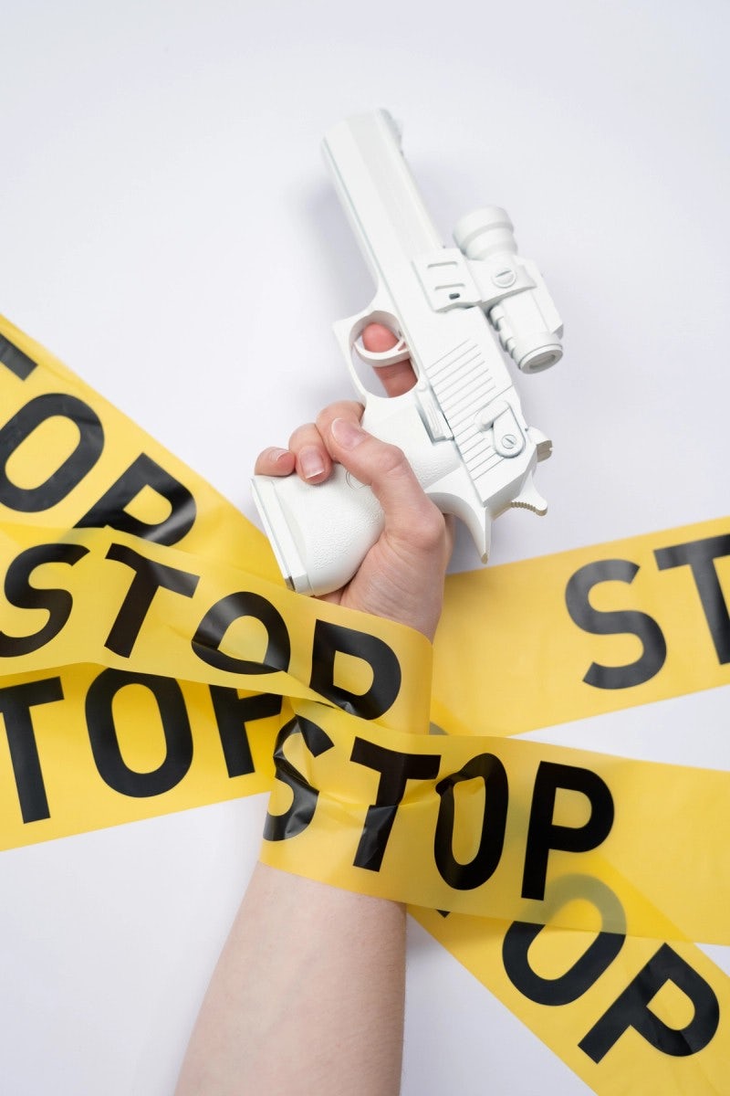 Gun with stop sign tape