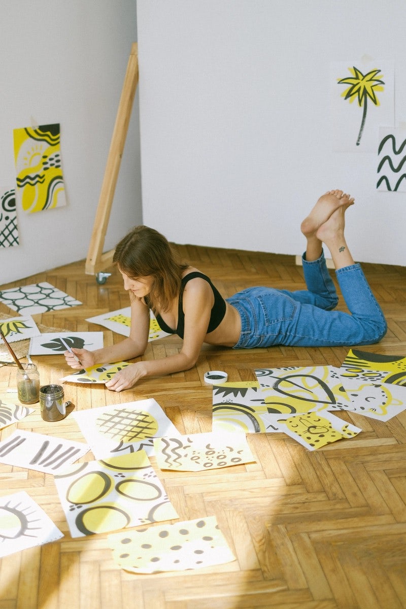 woman surrounded by drawings